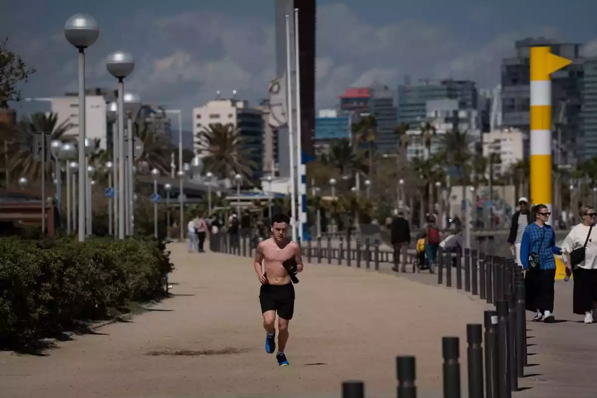 Un home corre per Barcelona amb les temperatures altes d?aquest abril, pròpies del juny