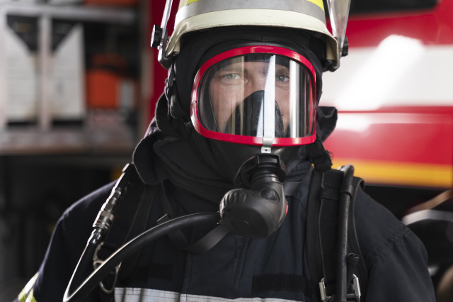 Firefighterstationequippedwithprotectivesuitfiremask