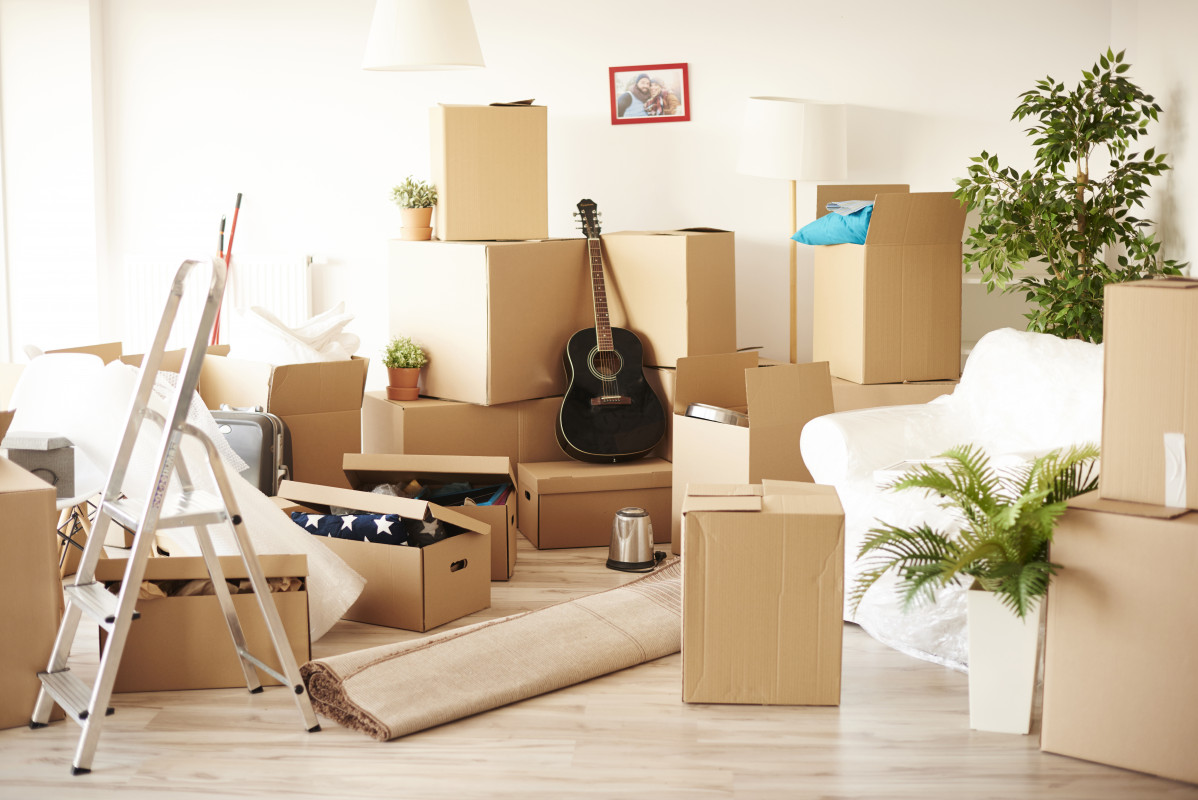 Top view of room full of messy moving boxes